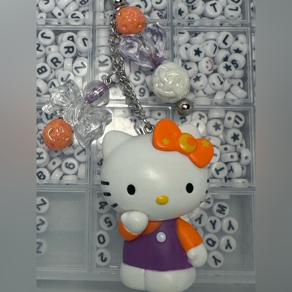 Cute Hello Kitty Character Keychains with Purple and Orange Accents - Picture 2 of 7